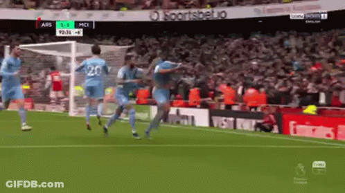 A Group Of Soccer Players Celebrate A Goal On A Field GIF