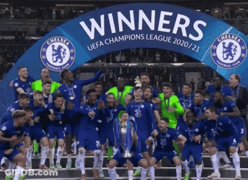 A Group Of Soccer Players Celebrate With A Banner That Says Winners GIF