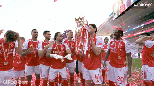 A Group Of Soccer Players Celebrate With A Trophy And Confetti GIF