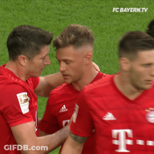 A Group Of Soccer Players From Fc Bayern.tv Are Hugging GIF