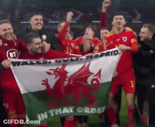 A Group Of Soccer Players Hold A Flag That Says In That Order GIF