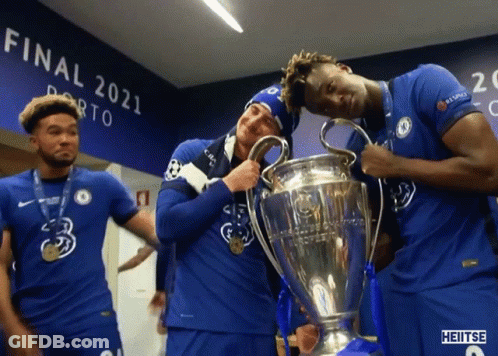 A Group Of Soccer Players Holding A Trophy In Front Of A Wall That Says Final 2021 GIF