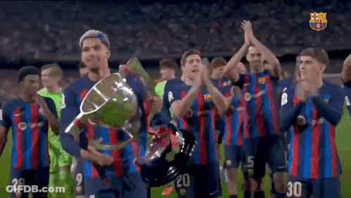 A Group Of Soccer Players Holding A Trophy With The Number 30 On The Back GIF