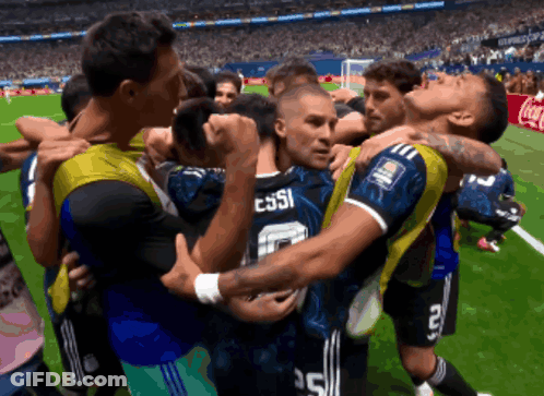 A Group Of Soccer Players Huddle Around A Player With Messi On The Back Of His Jersey GIF