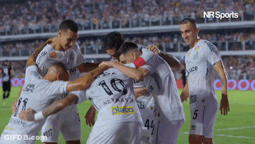 A Group Of Soccer Players Huddle Together With One Wearing The Number 10 On His Back GIF