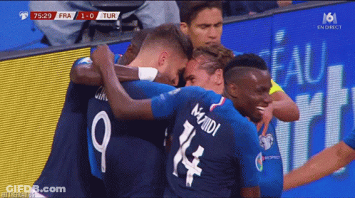 A Group Of Soccer Players Hugging Each Other With The Number 9 On The Back GIF
