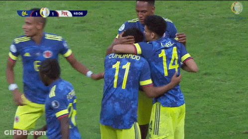 A Group Of Soccer Players Hugging One Another With The Number 11 On The Back GIF