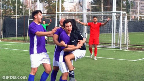 A Group Of Soccer Players In Purple And White Uniforms Are Celebrating A Goal GIF