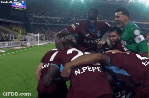 A Group Of Soccer Players Including N.pepe Are Huddled Together On A Field GIF