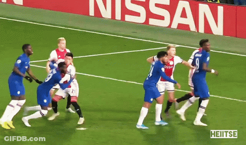 A Group Of Soccer Players On A Field In Front Of A Nissan Sign GIF