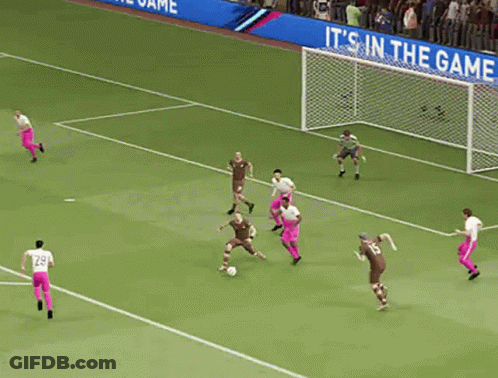 A Group Of Soccer Players On A Field With A Goalie In The Background GIF