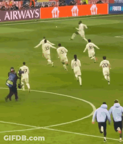 A Group Of Soccer Players On A Field With A Sign That Says That #Uclfeeling GIF
