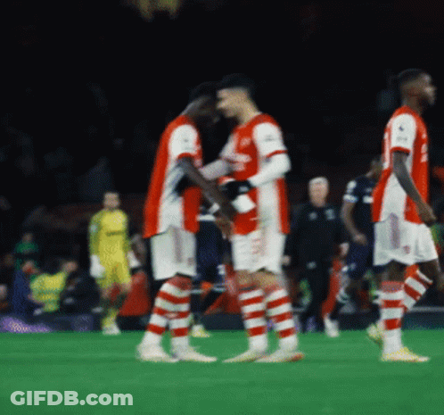 A Group Of Soccer Players On A Field With One Wearing A Jersey That Says ' Arsenal ' GIF