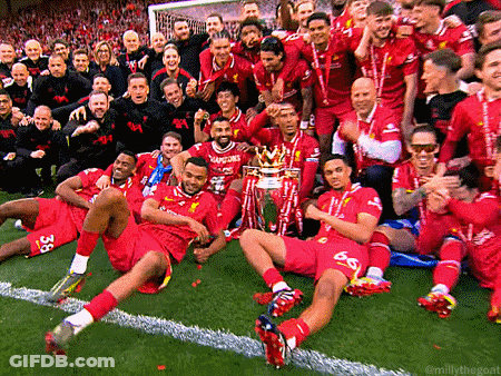A Group Of Soccer Players Posing For A Photo With A Trophy GIF