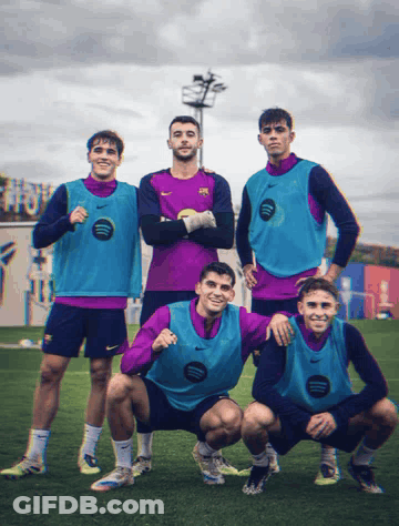 A Group Of Soccer Players Posing For A Picture With One Wearing A Nike Vest That Says Spotify GIF
