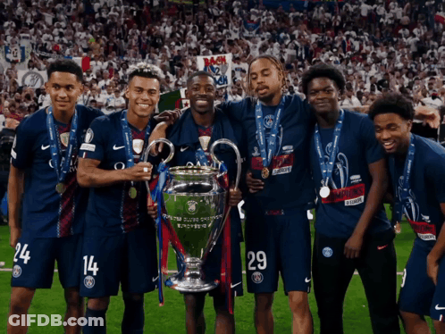 A Group Of Soccer Players Posing For A Picture With The Trophy GIF