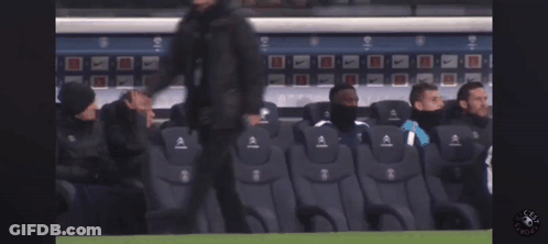 A Group Of Soccer Players Sit In A Stadium Watching A Game GIF