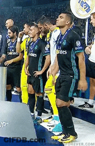 A Group Of Soccer Players Standing Next To Each Other On The Field . GIF