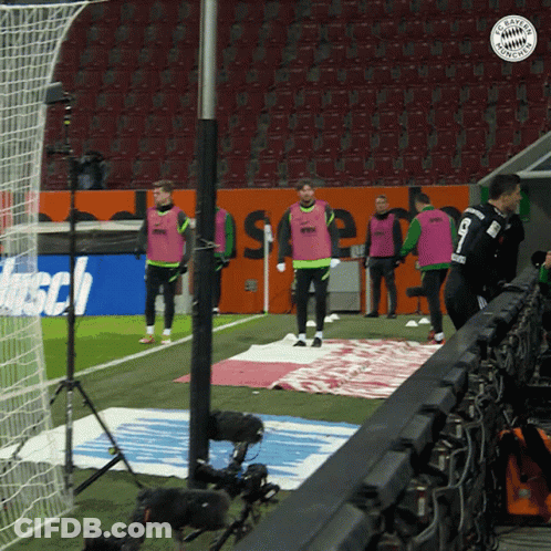 A Group Of Soccer Players Standing On A Field With A Bayern Munchen Logo GIF