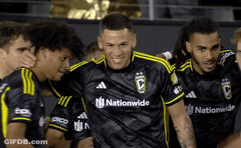 A Group Of Soccer Players Wearing Black Jerseys With The Word Nationwide On Them GIF