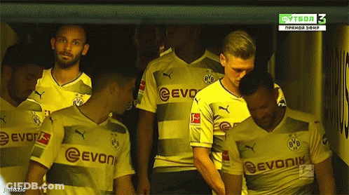 A Group Of Soccer Players Wearing Evonik Jerseys Stand In A Locker Room GIF