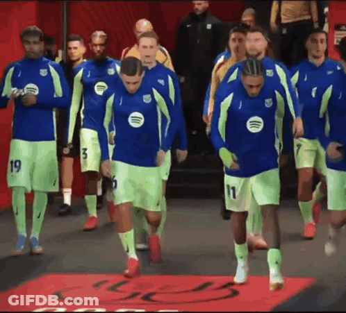 A Group Of Soccer Players Wearing Neon Green And Blue Jerseys With Spotify Logos On Them GIF