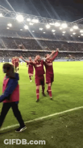 A Group Of Soccer Players Wearing Qatar Jerseys Celebrate GIF