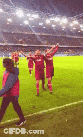 A Group Of Soccer Players Wearing Qatar Jerseys Celebrate GIF