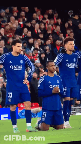 A Group Of Soccer Players Wearing Qatar Jerseys Stand On A Field GIF