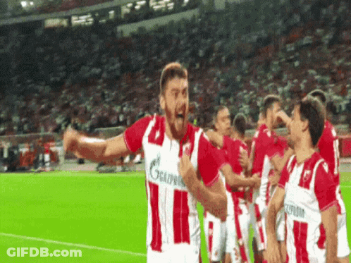 A Group Of Soccer Players Wearing Red And White Jerseys With The Number 11 On Them GIF