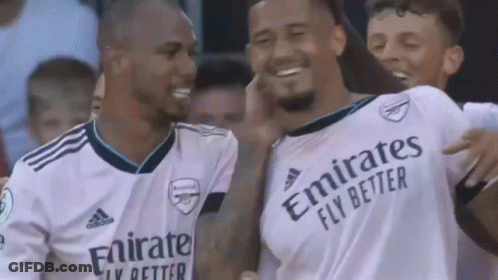 A Group Of Soccer Players Wearing White Jerseys With Emirates Fly Better Written On Them Are Standing Next To Each Other GIF