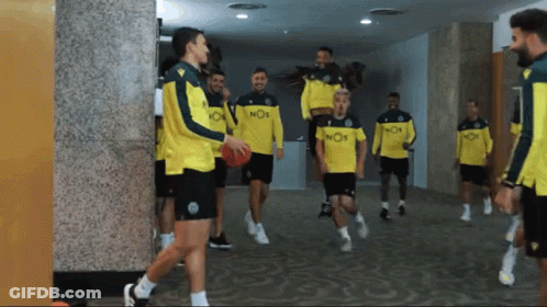 A Group Of Soccer Players Wearing Yellow Jerseys With Nos On Them GIF