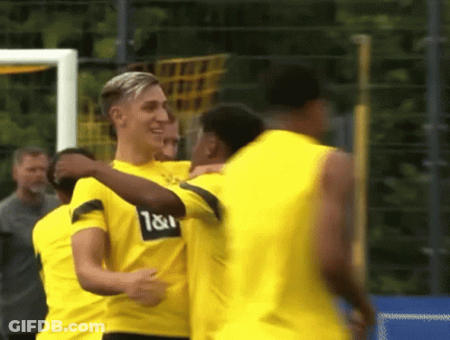 A Group Of Soccer Players Wearing Yellow Shirts With The Letters T & I On Them GIF