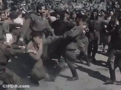 A Group Of Soldiers Are Fighting In A Crowd . GIF