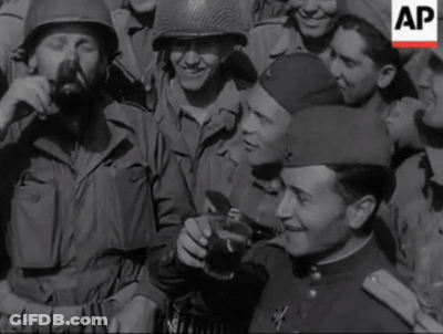 A Group Of Soldiers Are Gathered Around A Man Holding A Coca Cola Cup GIF