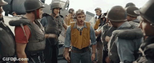 A Group Of Soldiers Are Gathered Around A Man Wearing A Yellow Vest With The Letter Y On It GIF