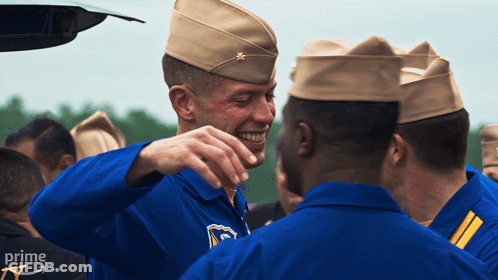 A Group Of Soldiers Are Gathered In Front Of A Car With The Word Prime On The Bottom Right GIF