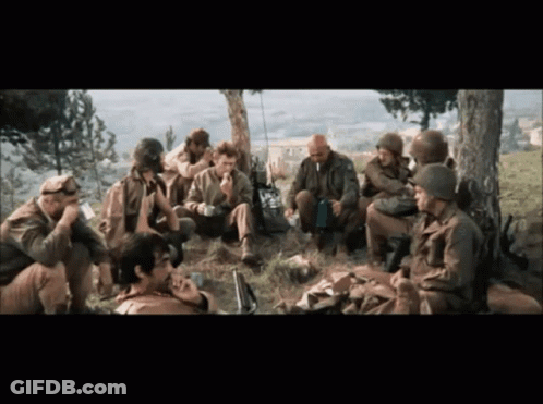 A Group Of Soldiers Are Gathered Under A Tree Talking GIF