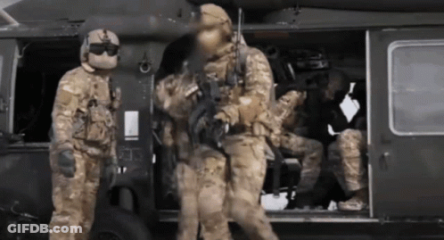 A Group Of Soldiers Are Getting Out Of A Military Helicopter GIF