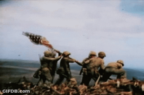 A Group Of Soldiers Are Holding An American Flag On Top Of A Hill GIF