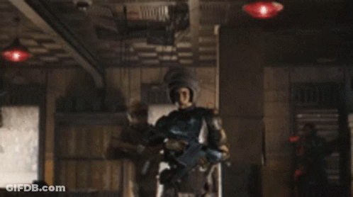 A Group Of Soldiers Are Holding Guns In A Dark Room . GIF