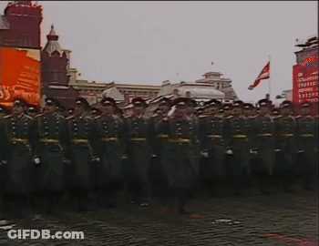 A Group Of Soldiers Are Marching In Front Of A Sign That Says ' Soviet Union ' On It GIF