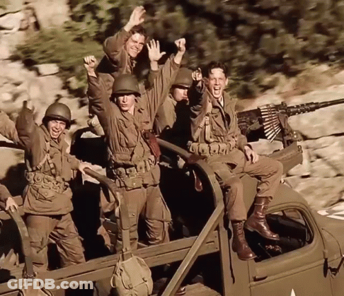 A Group Of Soldiers Are Riding In The Back Of A Vehicle GIF