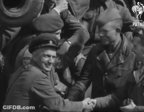 A Group Of Soldiers Are Shaking Hands In A Black And White Photo That Says Pathe GIF