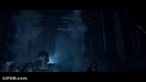 A Group Of Soldiers Are Standing In A Dark Room And One Of Them Is Wearing A Gas Mask GIF