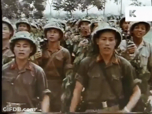 A Group Of Soldiers Are Standing In A Line With The Letter K Visible In The Corner GIF