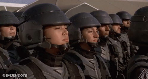 A Group Of Soldiers Are Standing In A Line With Their Eyes Closed And Their Helmets On GIF