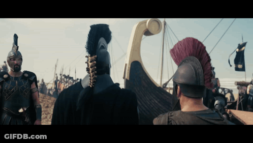 A Group Of Soldiers Are Standing In Front Of A Boat With A Banner That Says ' Rvs ' On It GIF