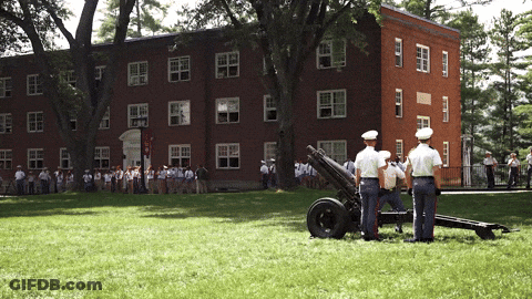 A Group Of Soldiers Are Standing In Front Of A Building GIF