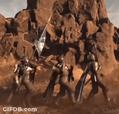 A Group Of Soldiers Carrying A Flag In Front Of A Large Rock Formation GIF